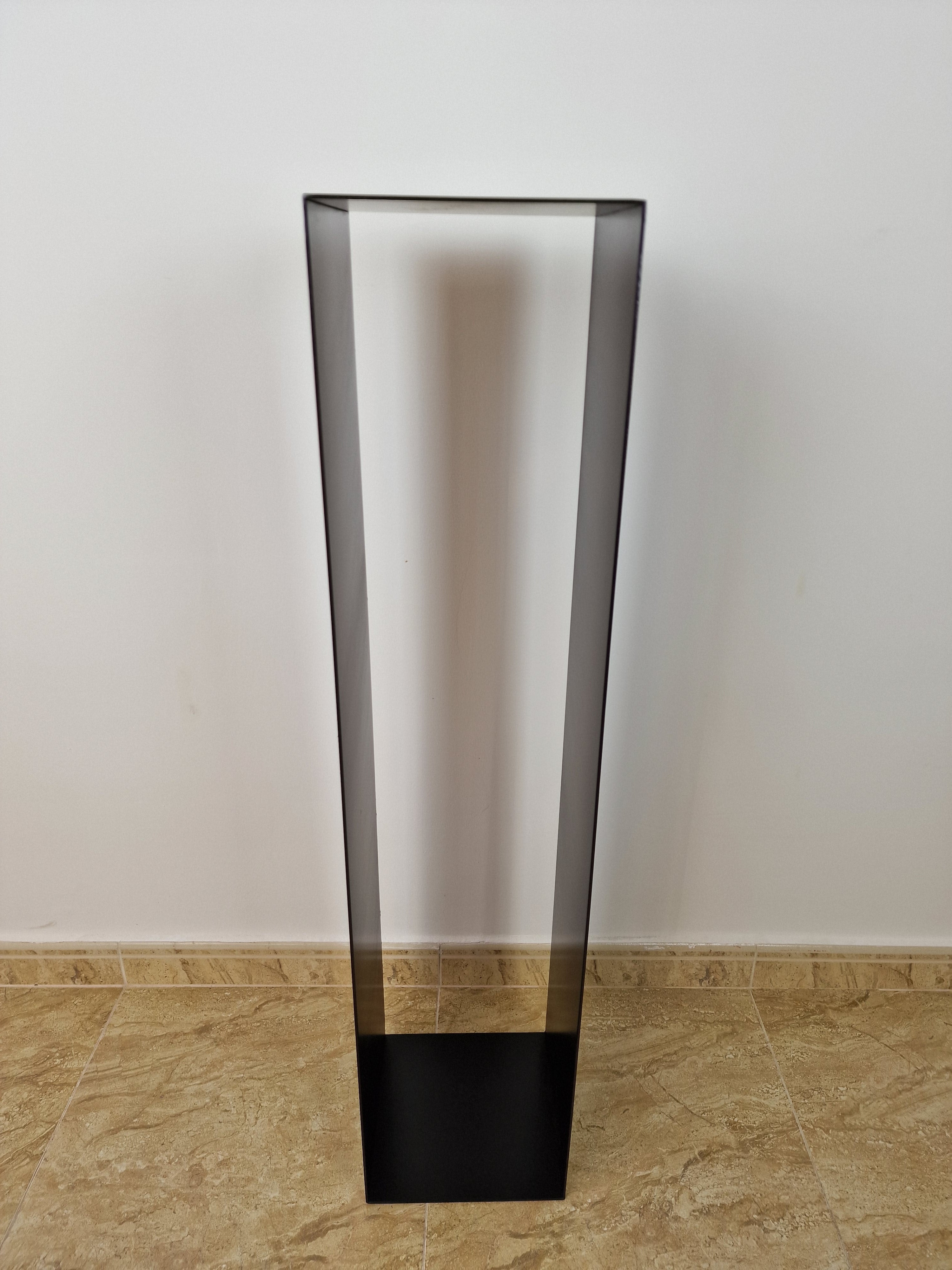 Peana negra de líneas limpias, ideal para resaltar esculturas en espacios modernos.