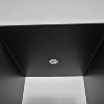 Soporte negro de forma simple y vertical, ideal para acompañar obras en interior.